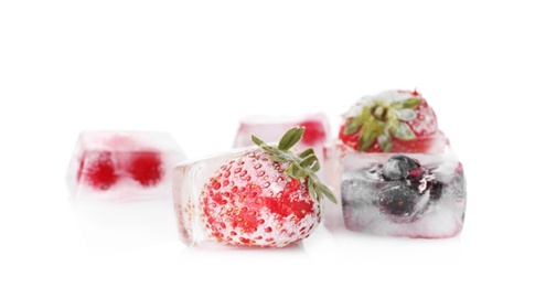 Photo of Fresh berries frozen in ice cubes on white background