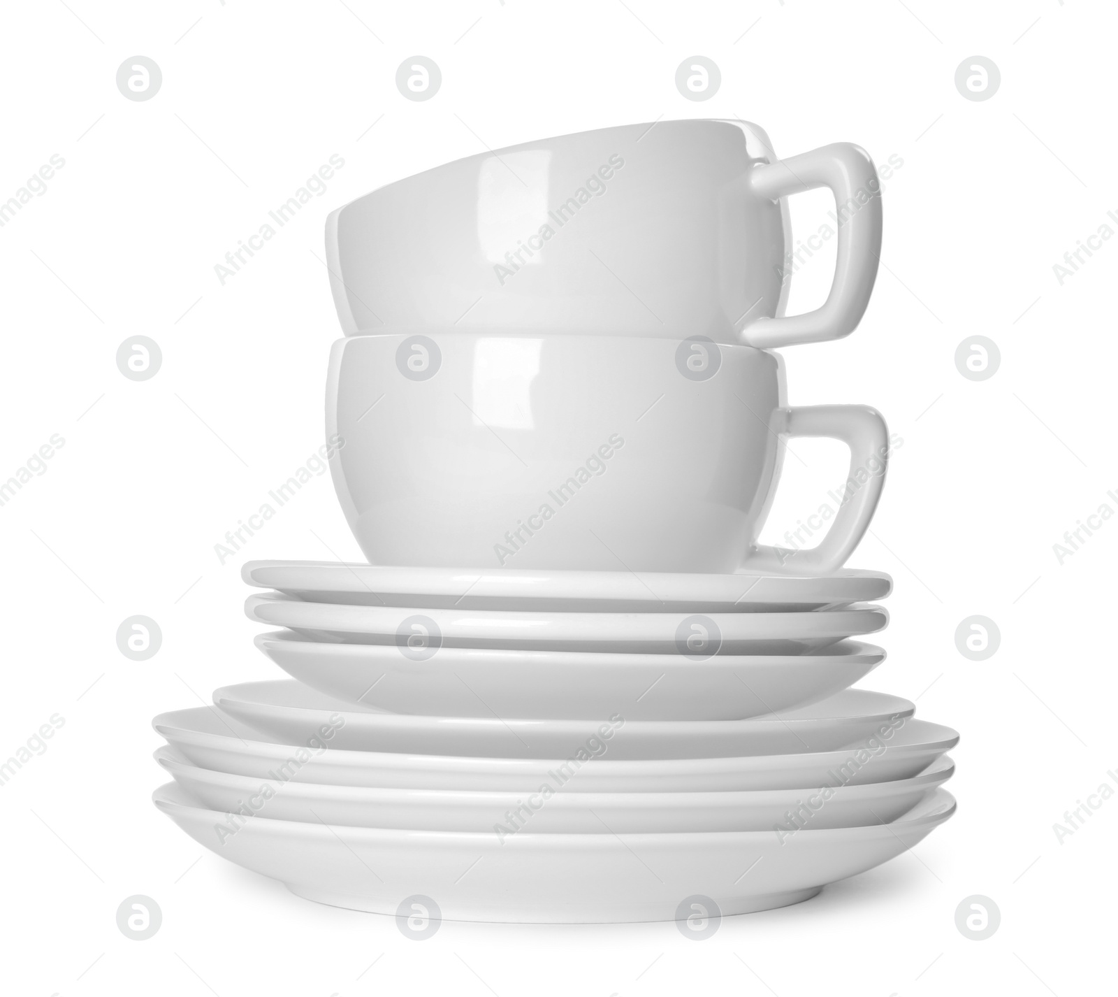 Photo of Stack of clean tableware isolated on white