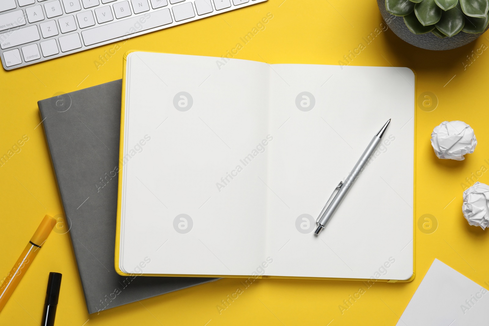 Photo of Flat lay composition with stylish notebooks on yellow background