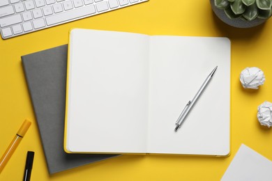 Flat lay composition with stylish notebooks on yellow background