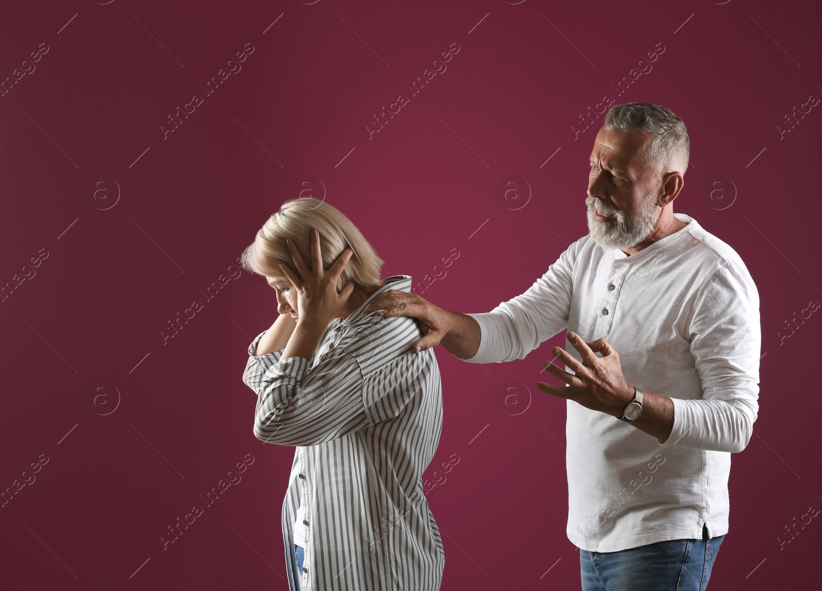 Photo of Mature couple having argument on color background. Relationship problems