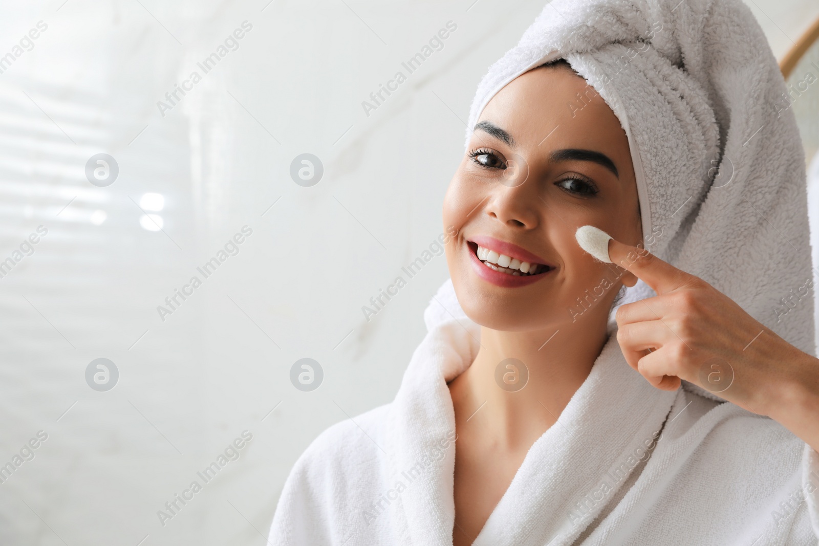 Photo of Woman using silkworm cocoon in skin care routine at home. Space for text