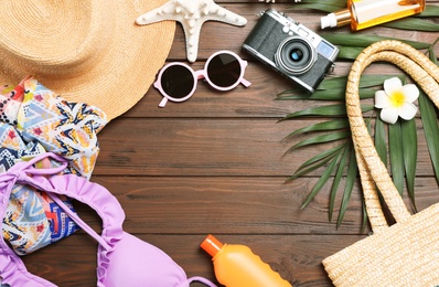 Photo of Flat lay composition with beach objects on wooden background