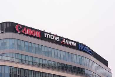 Photo of Warsaw, Poland - September 10, 2022: Building with many modern logos