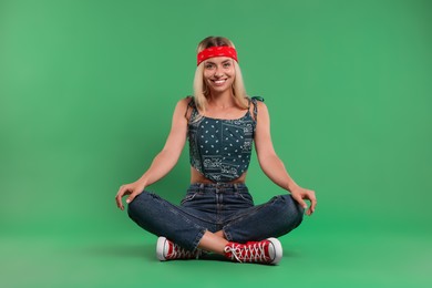 Photo of Portrait of happy hippie woman on green background