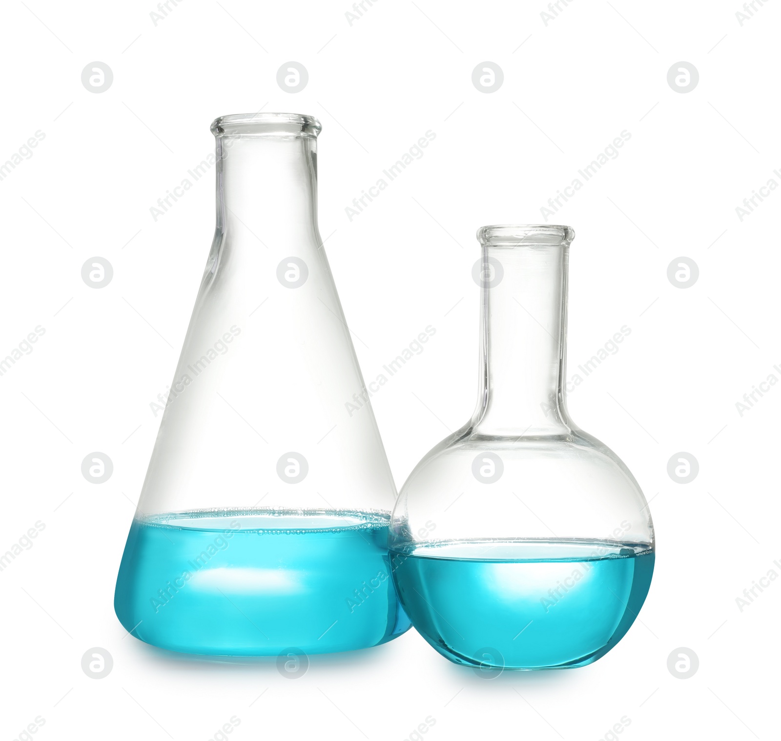 Photo of Laboratory glassware with liquid on white background. Solution chemistry