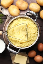 Flat lay composition with tasty mashed potatoes and ingredients on wooden table