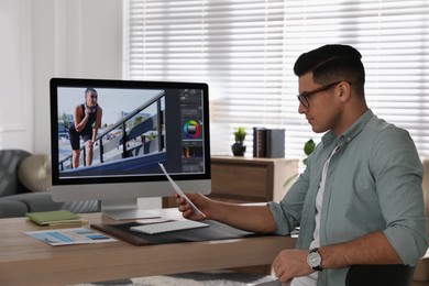 Professional retoucher working on computer in office