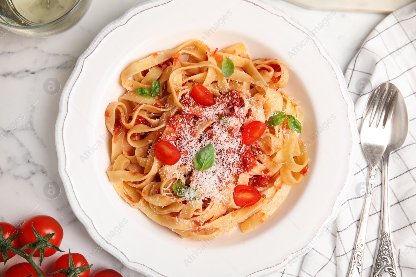 Photo of Flat lay composition with tasty pasta on white marble table