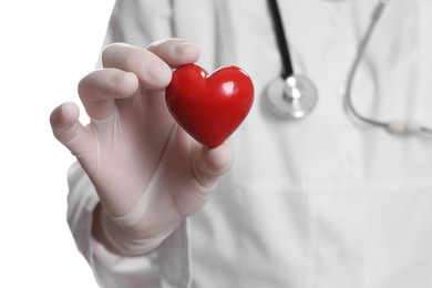 Photo of Doctor in medical glove holding red heart on white background, selective focus