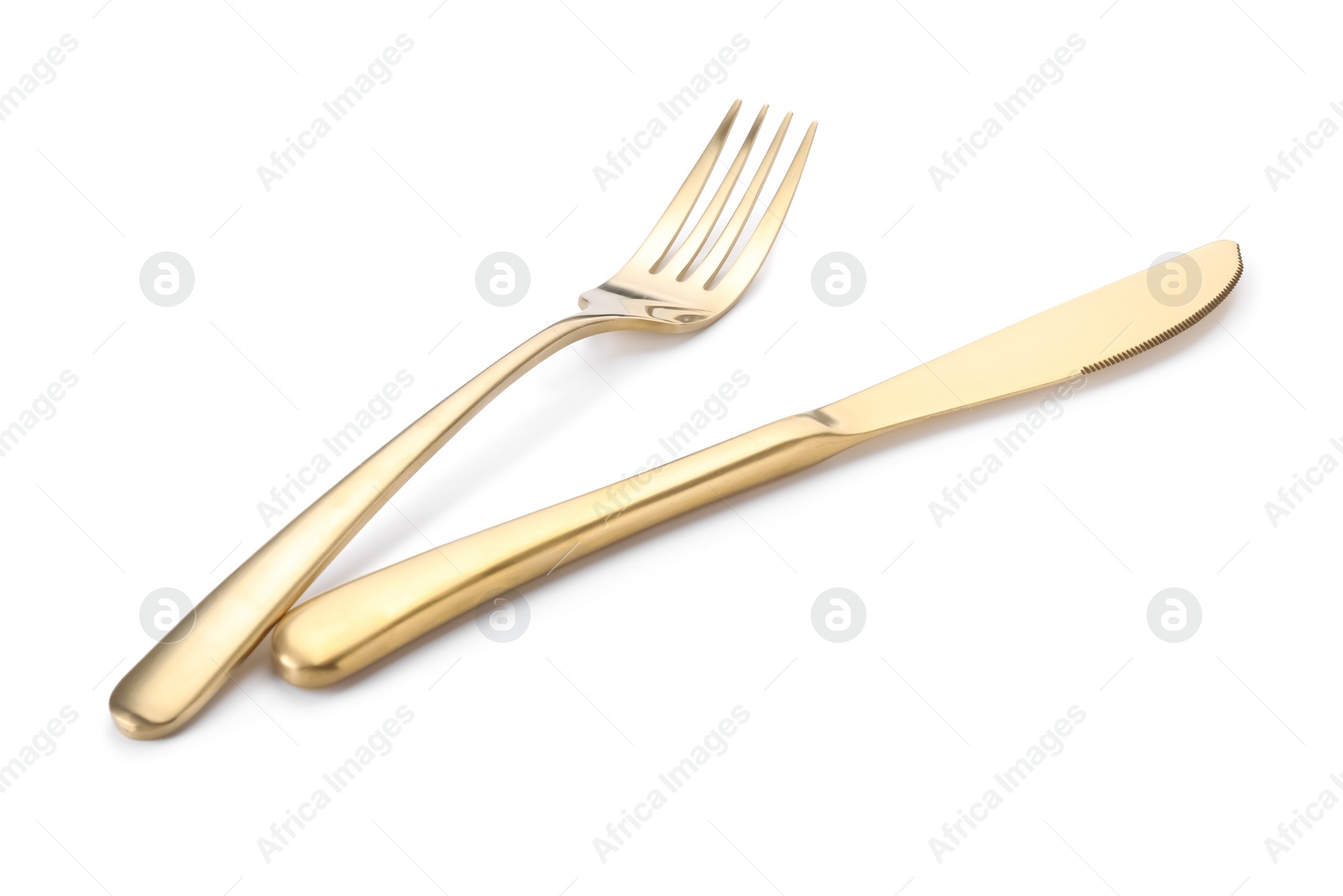 Photo of Shiny golden fork and knife isolated on white. Luxury cutlery