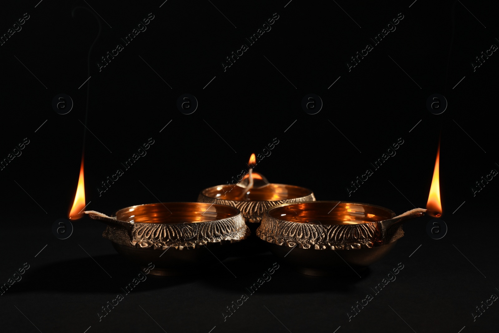 Photo of Diwali diyas or clay lamps on dark background