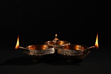Diwali diyas or clay lamps on dark background