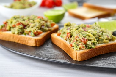 Delicious sandwiches with guacamole on white table, closeup