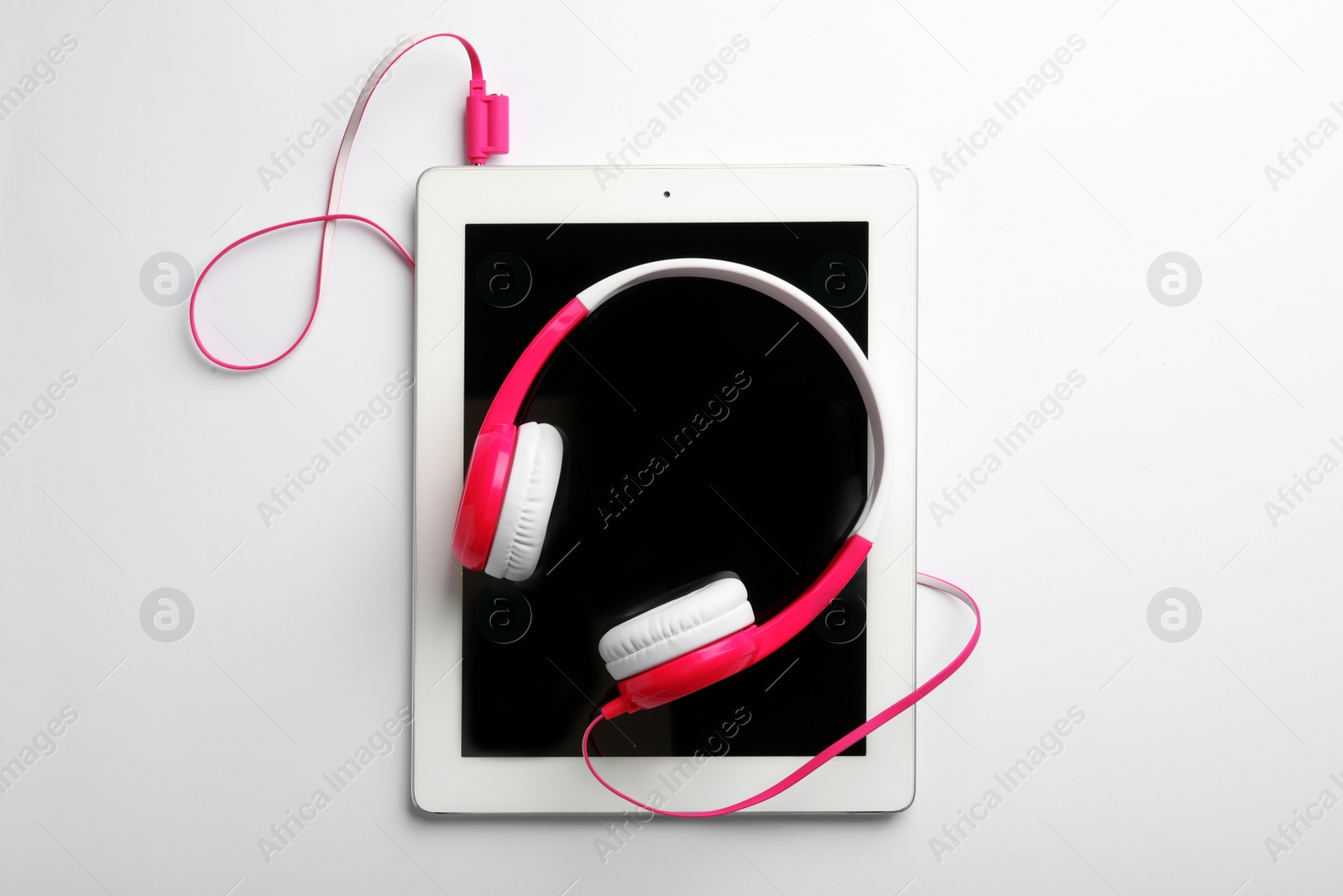 Photo of Stylish headphones and modern tablet on white background, top view