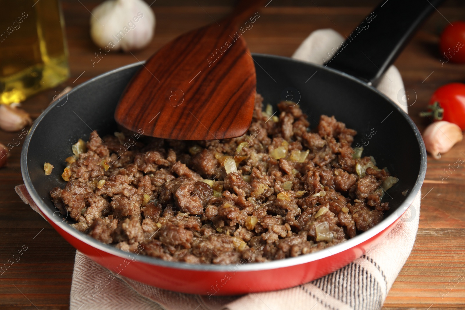 Photo of Fried minced meat with onion on wooden table, closeup