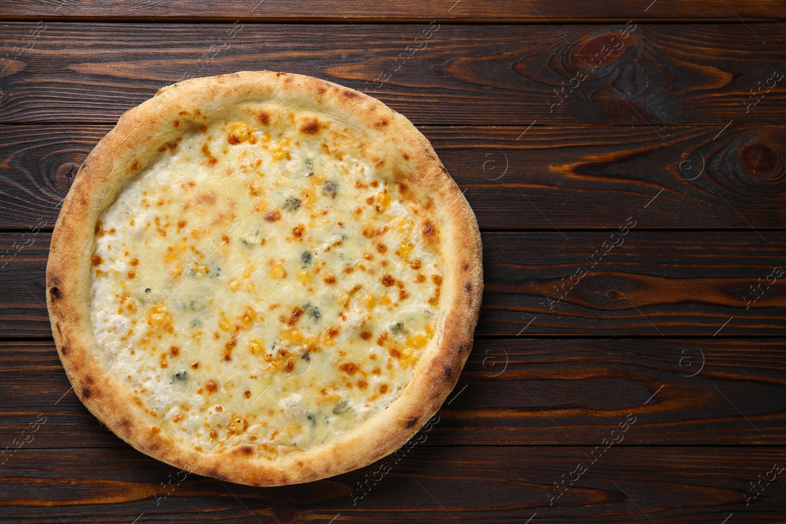 Photo of Delicious cheese pizza on wooden table, top view. Space for text