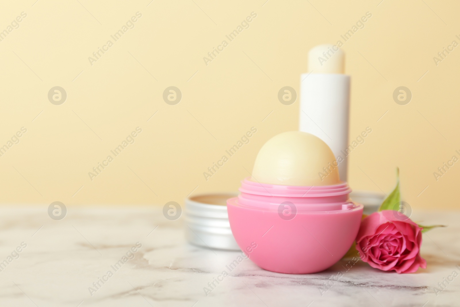 Photo of Composition with hygienic lipstick and balms on table