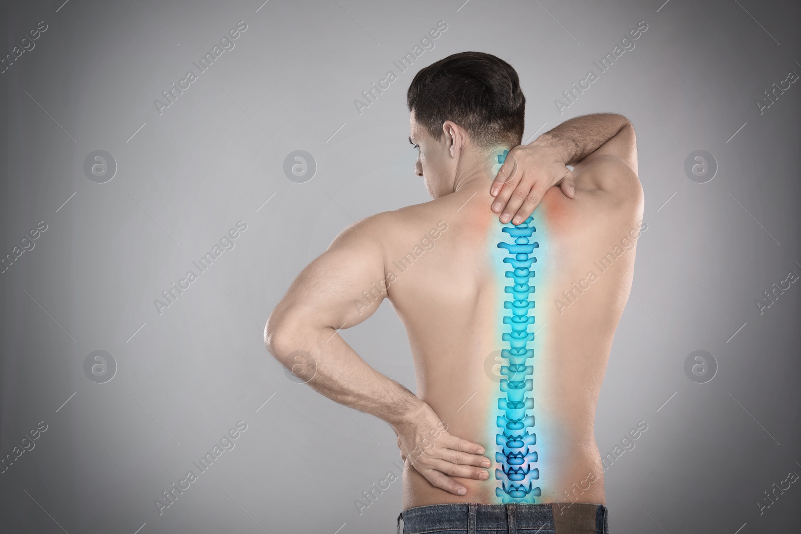 Image of Man suffering from pain in spine on grey background