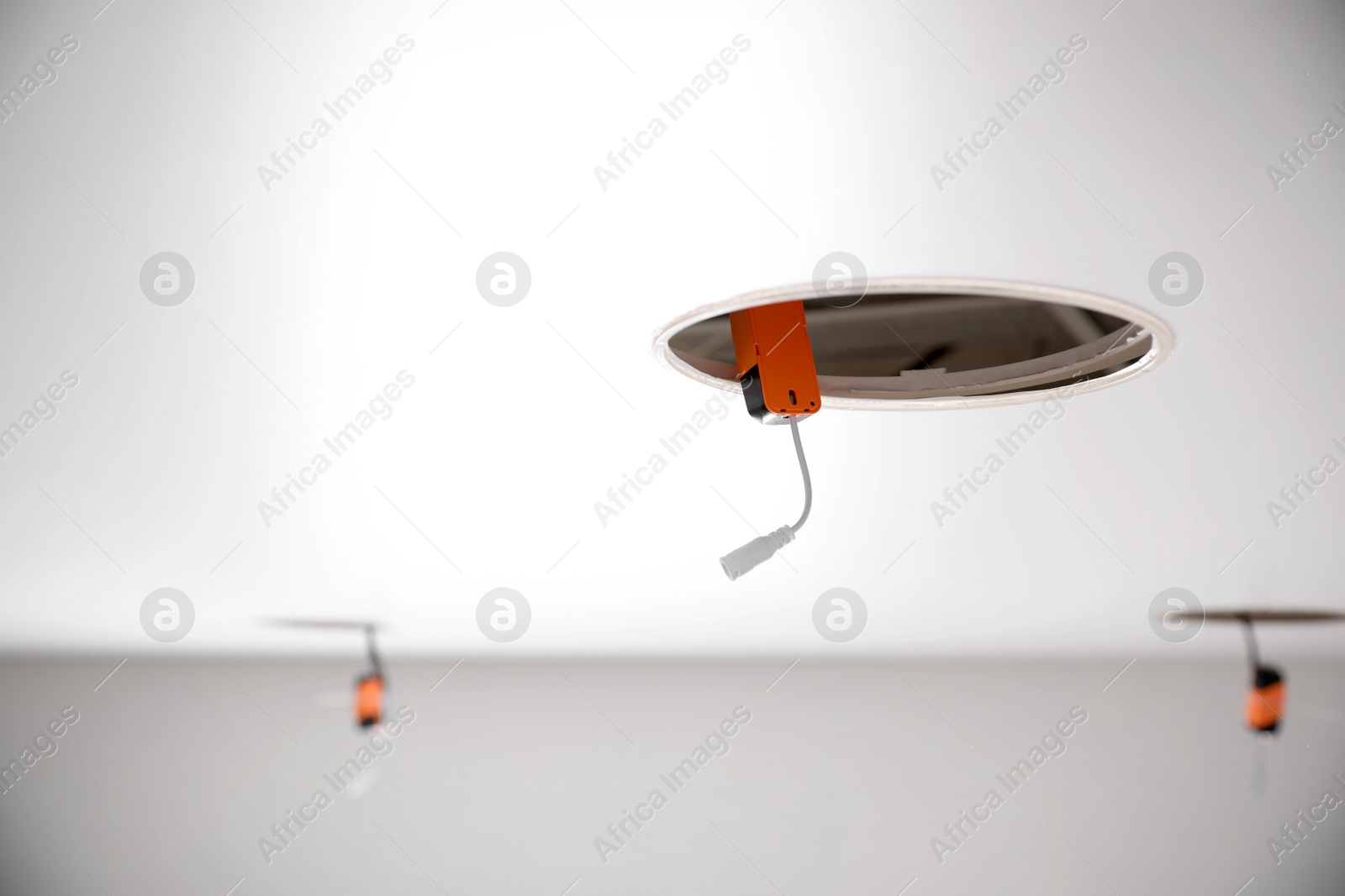 Photo of Stretch ceiling with electric ballast for lamp indoors. Space for text