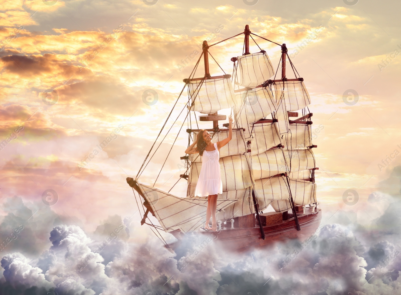 Image of Dream world. Sailing ship with beautiful girl on board floating among wonderful fluffy clouds