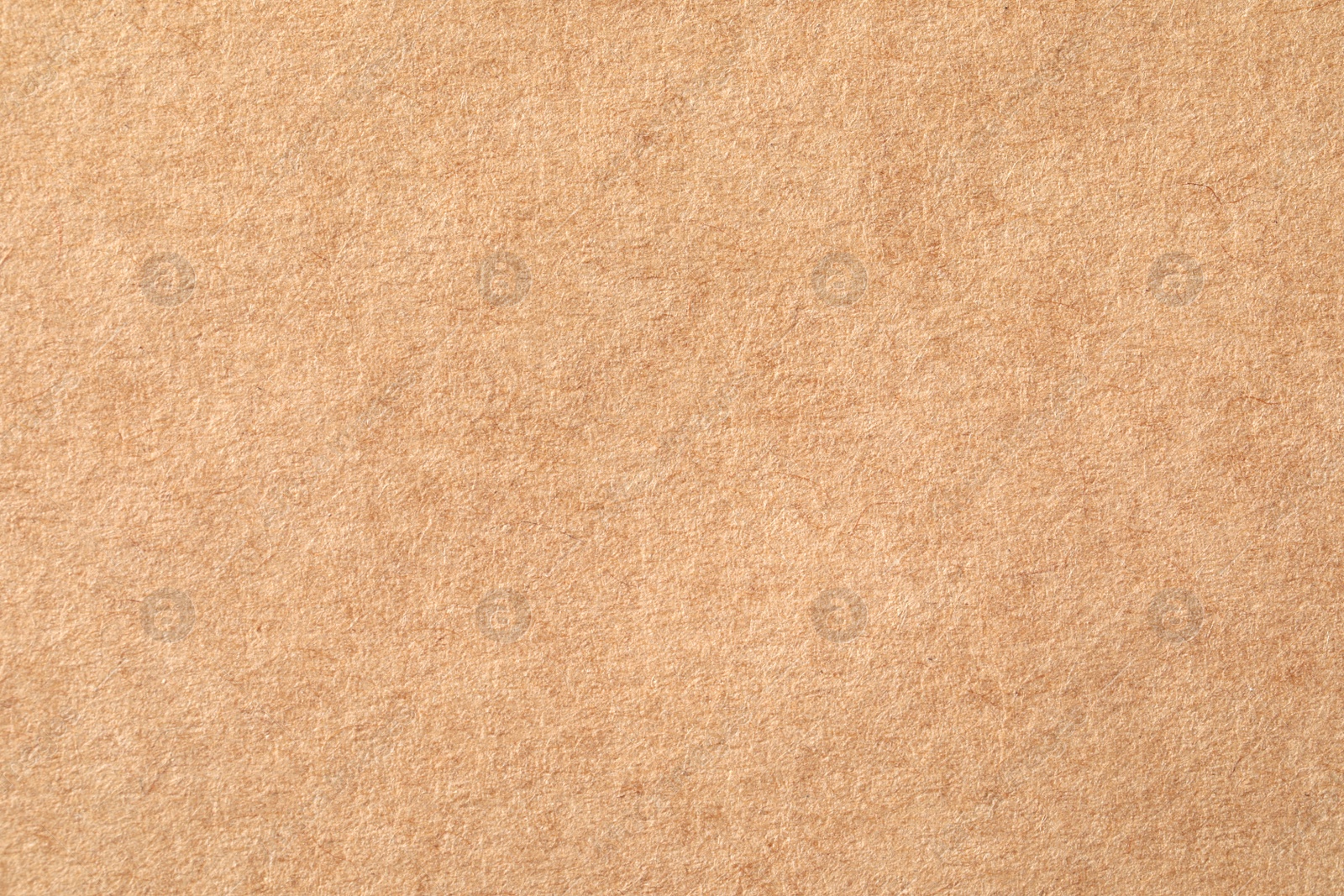 Photo of Texture of kraft paper sheet as background, closeup