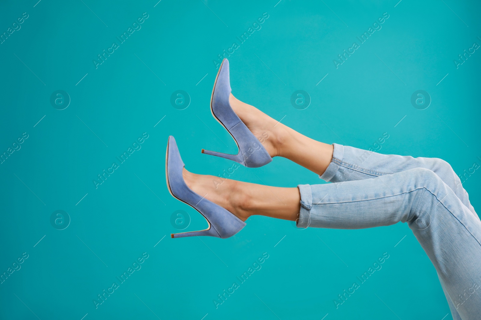 Photo of Woman in elegant shoes on light blue background