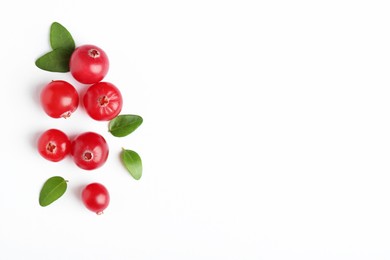 Photo of Fresh ripe cranberries and green leaves on white background, flat lay. Space for text