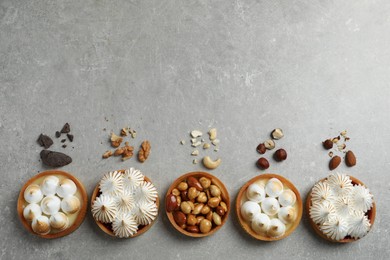 Photo of Many different tartlets on grey table, flat lay with space for text. Delicious dessert
