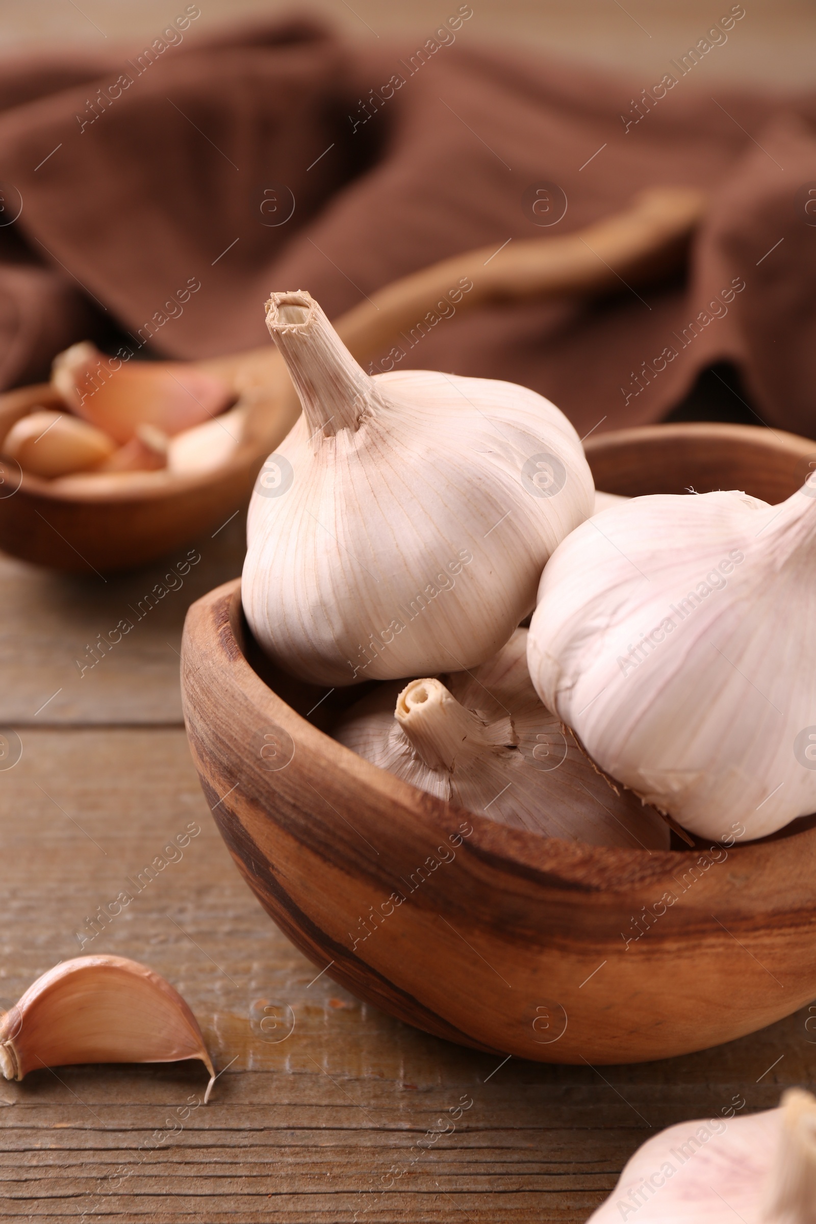 Photo of Fresh garlic on wooden table, closeup view