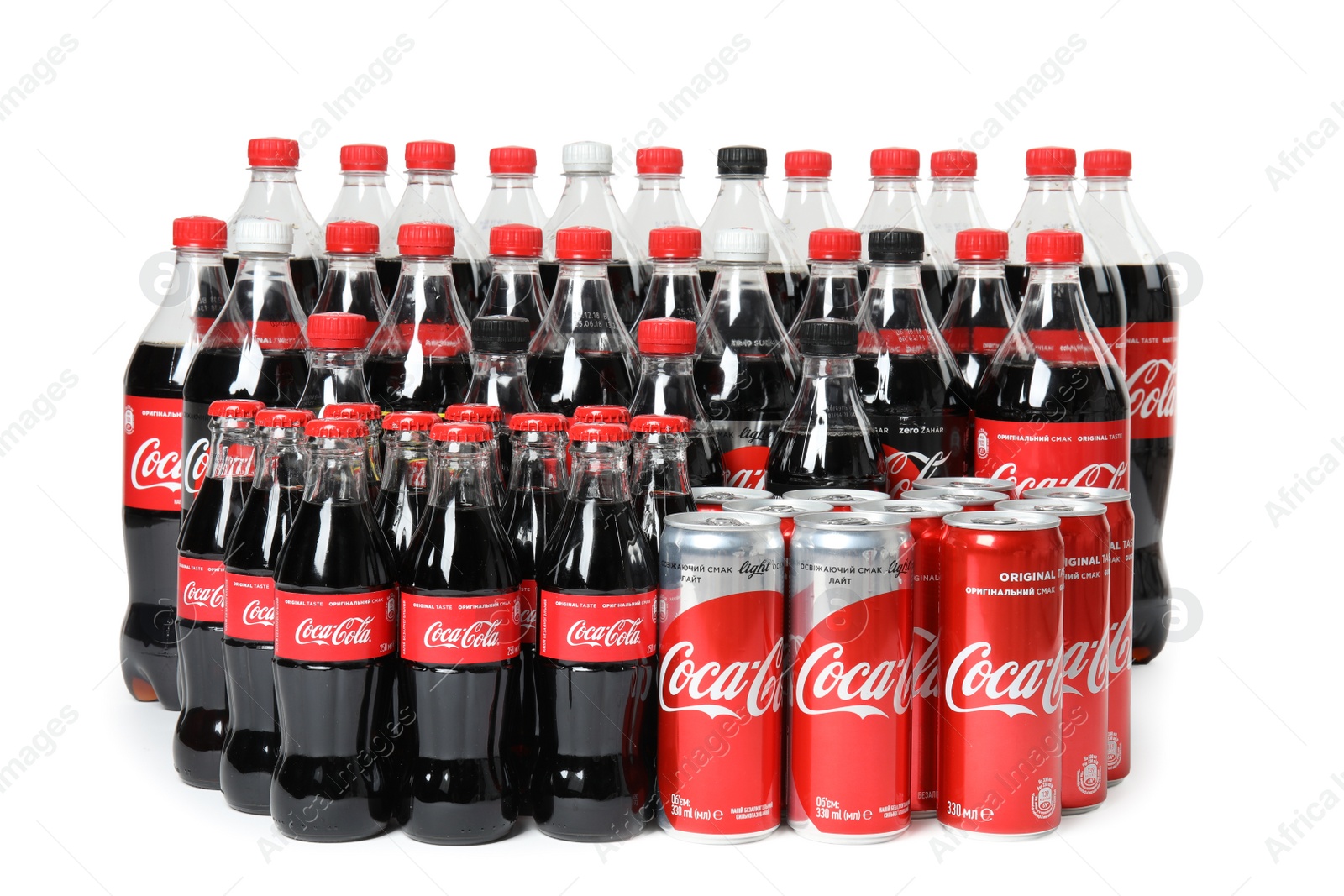 Photo of MYKOLAIV, UKRAINE - NOVEMBER 16, 2018: Bottles and cans with Coca-Cola on white background