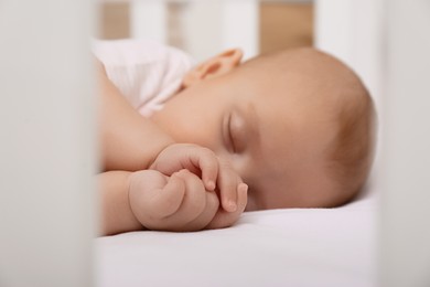 Cute little baby sleeping in crib, closeup