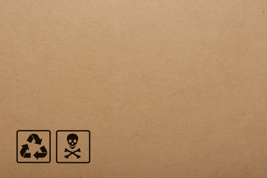 Cardboard box with packaging symbols as background, closeup