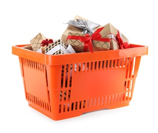 Photo of Orange shopping basket with different gifts on white background