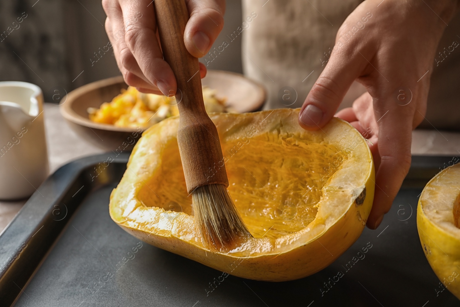 Photo of Woman preparing spaghetti squash on table, closeup