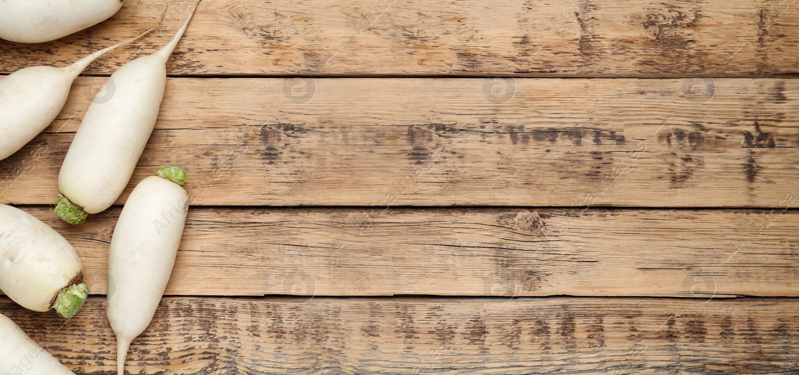 Image of White turnips on wooden table, flat lay. Space for text