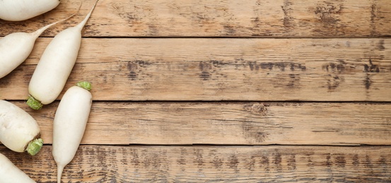 Image of White turnips on wooden table, flat lay. Space for text