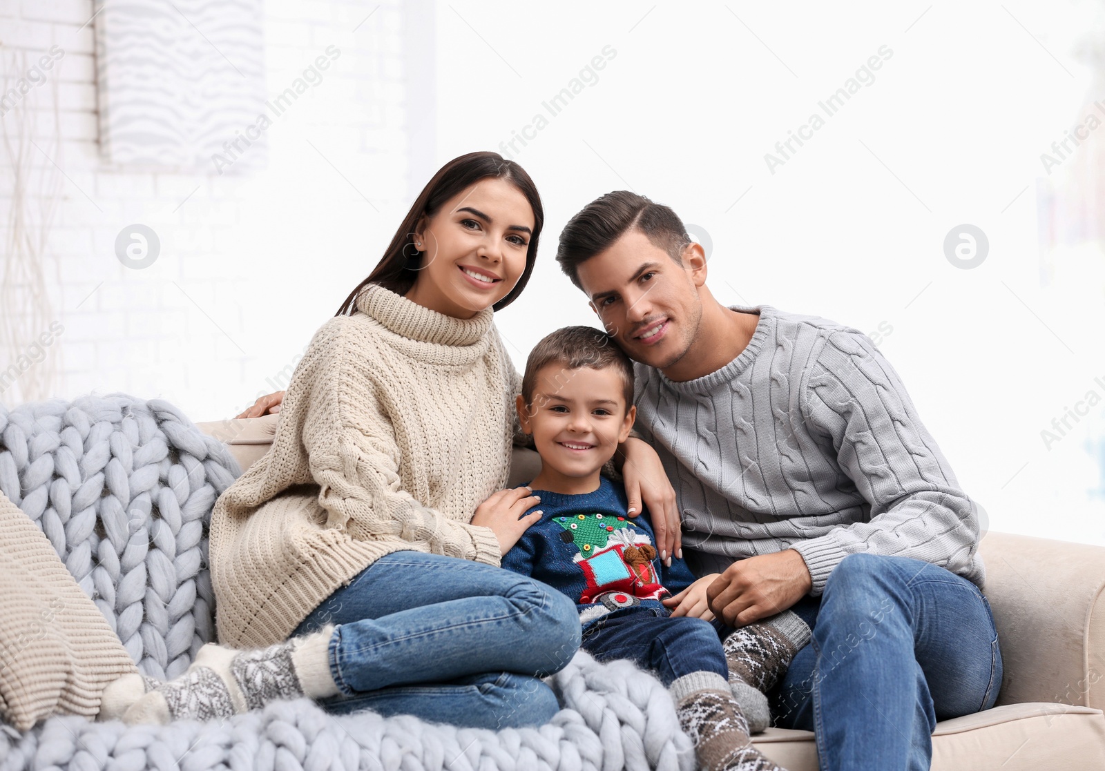 Photo of Happy family with little son spending time together at home. Winter vacation