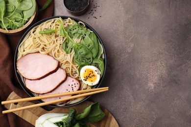 Photo of Delicious ramen with meat served on grey table, flat lay and space for text. Noodle soup