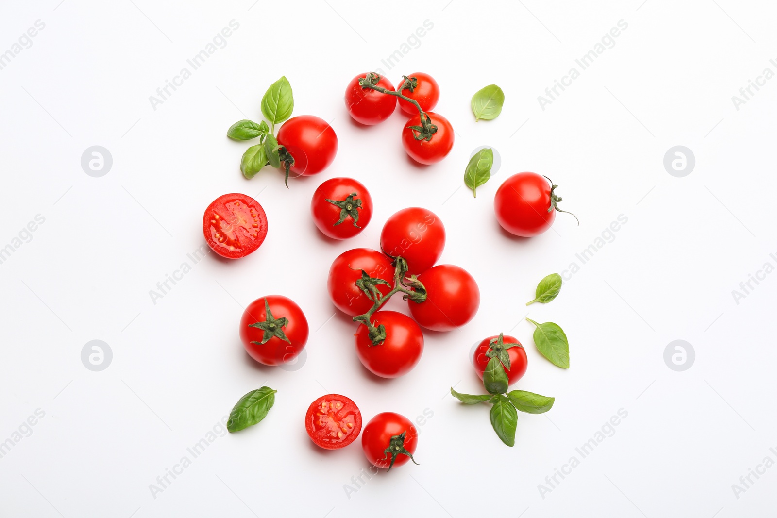 Photo of Fresh cherry tomatoes and basil leaves on white background, top view