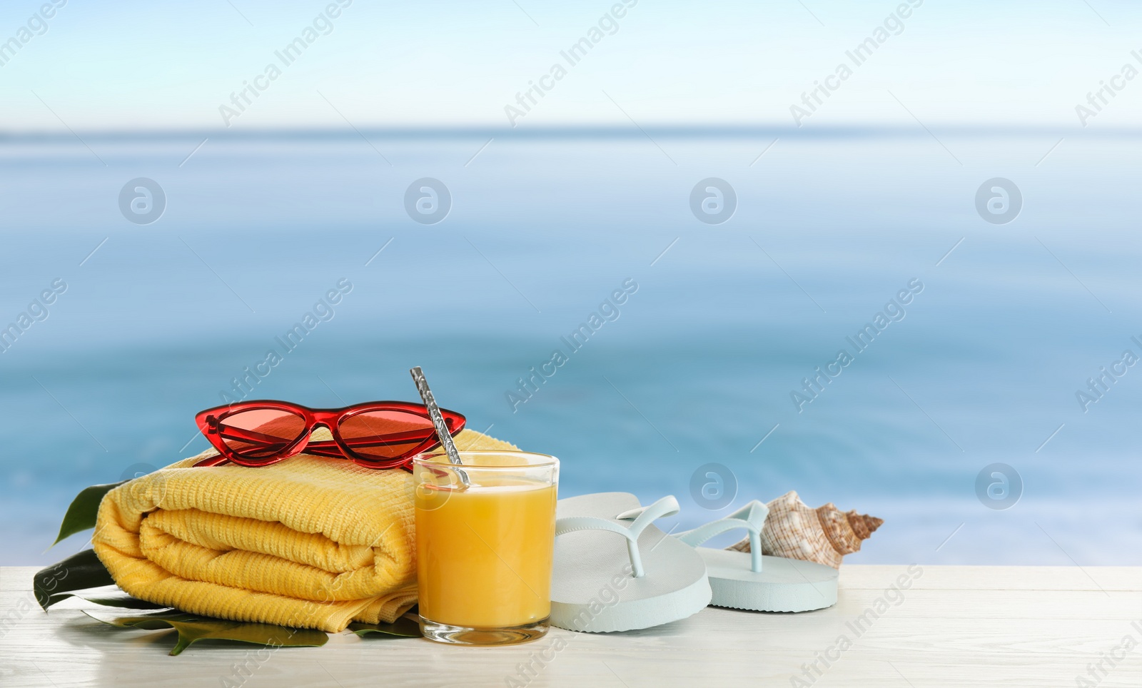 Image of Different beach objects on wooden surface near sea