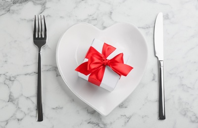 Photo of Beautiful table setting for Valentine's Day dinner on white marble background, flat lay