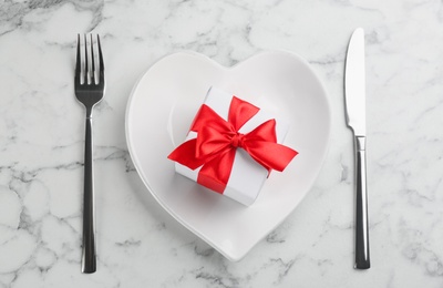 Beautiful table setting for Valentine's Day dinner on white marble background, flat lay