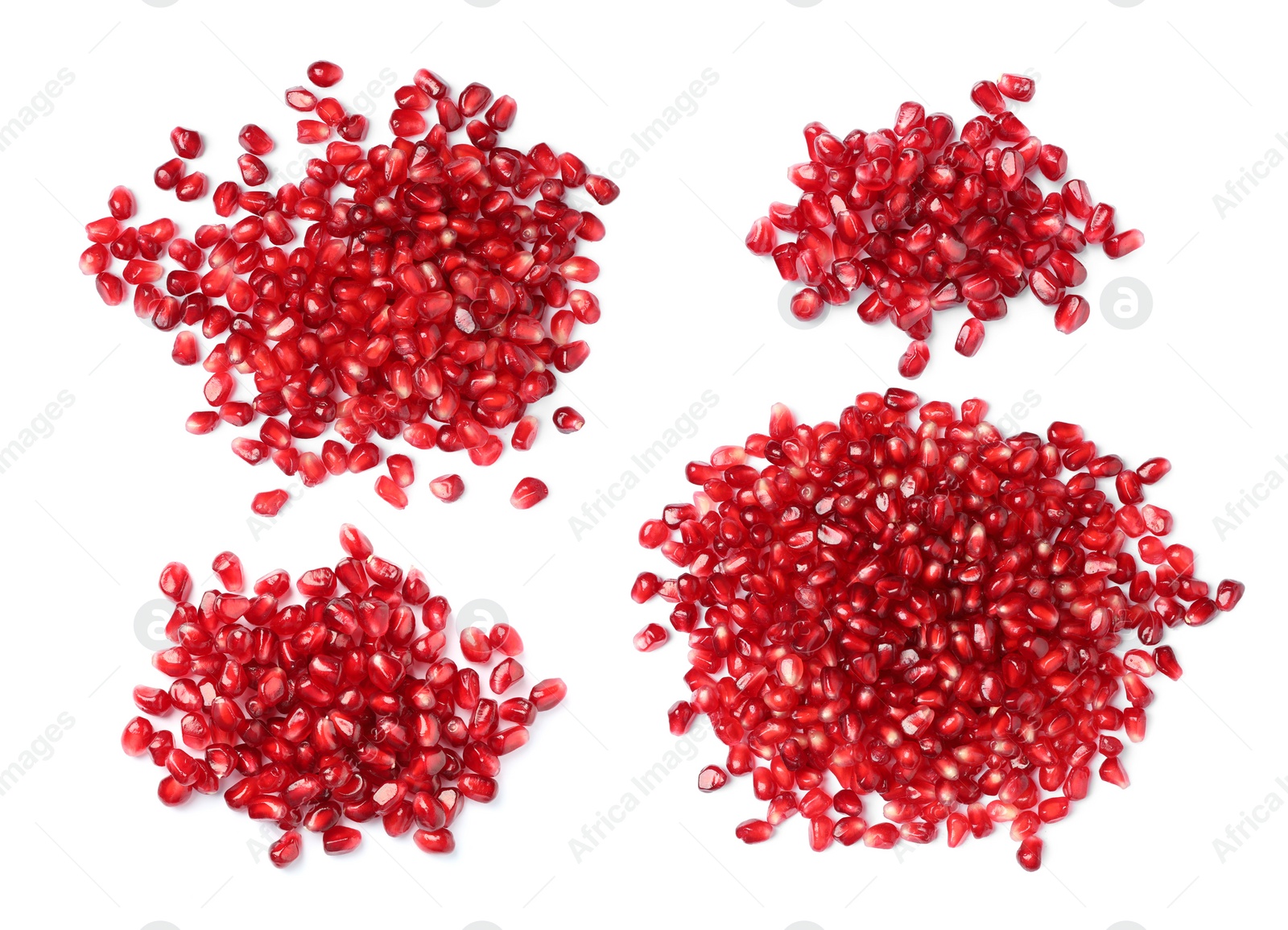 Image of Set with ripe juicy pomegranate seeds on white background, top view 