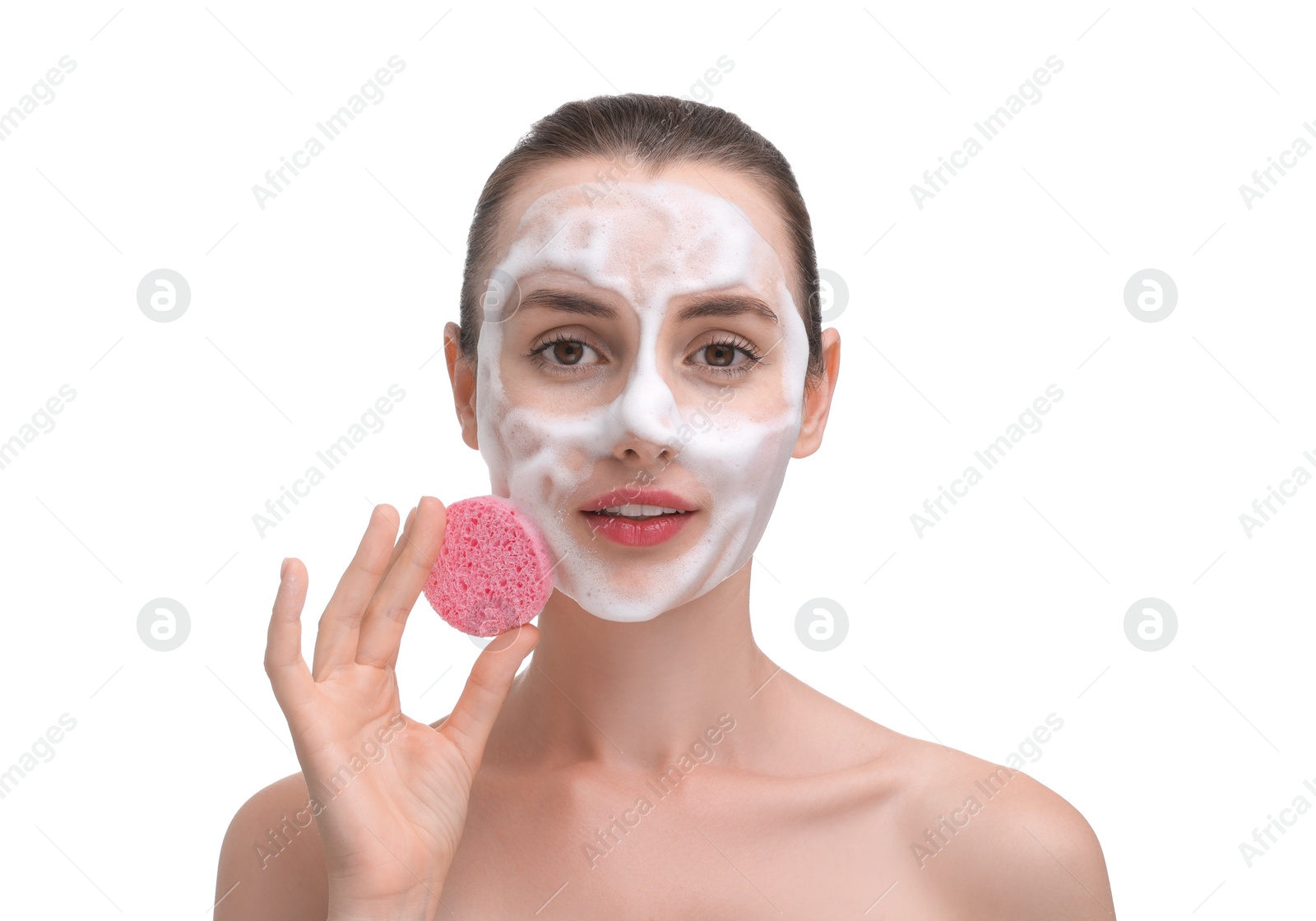 Photo of Young woman washing her face with sponge on white background