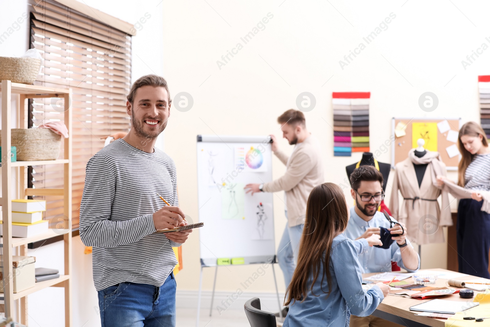 Photo of Fashion designers creating new clothes in studio