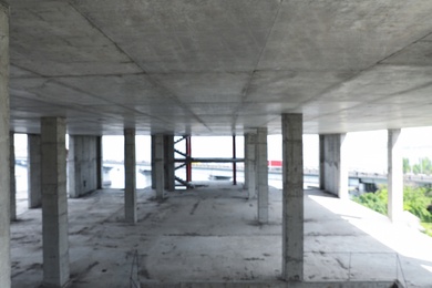 Photo of Blurred view of unfinished building indoors. Construction safety rules