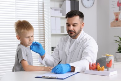 Photo of Little boy having appointment with endocrinologist at hospital