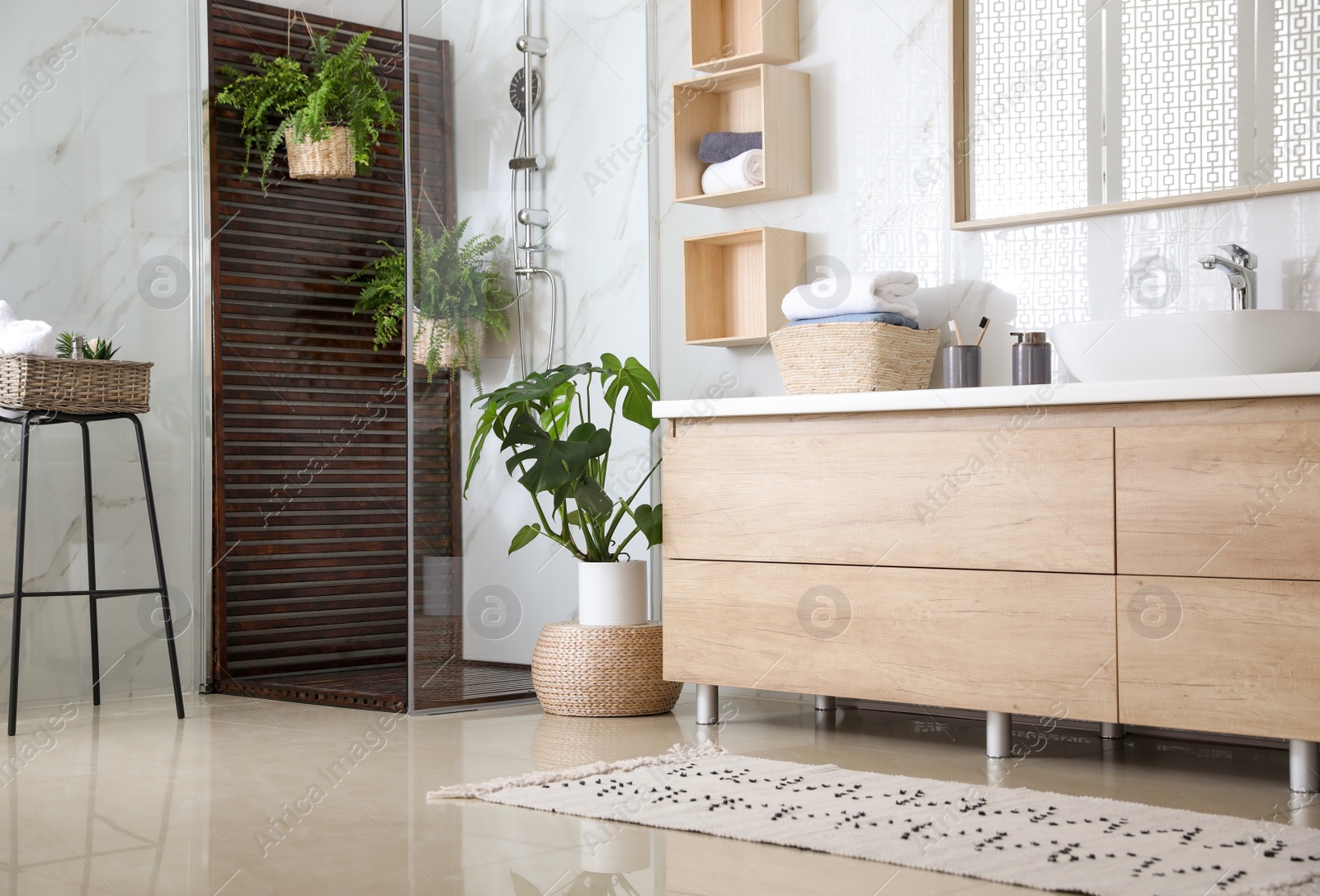 Photo of Bathroom interior with shower stall and houseplants. Idea for design