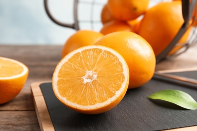 Photo of Fresh juicy oranges on cutting board. Healthy fruit